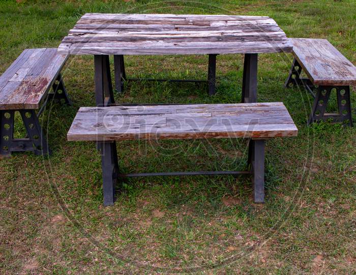A Wooden Picnic Bench Used For Eating Outdoor. Park Bench For Recreation.