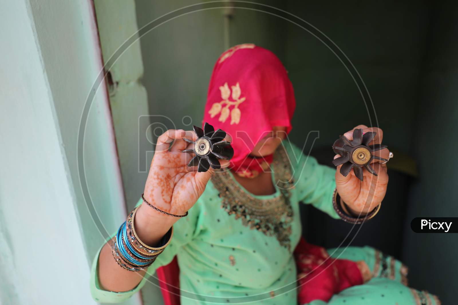 Border villager woman holds the tail unit of a mortar shell allegedly fired from the Pakistani side of the  border in Manyari village of Kathua about 65 kms from Jammu,11 November,2020.