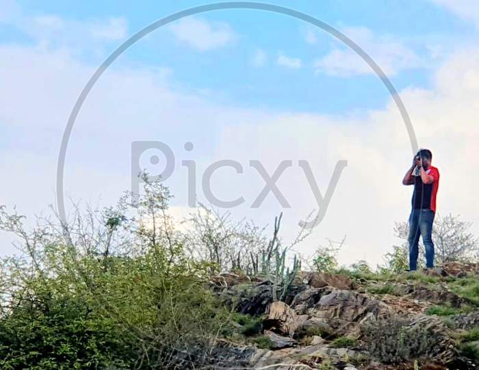 Boy photographing blue sky