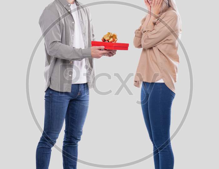 Couple Standing Isolated. Woman Suprised By Gift From Man. Man Making A Gift To Girl. Couple Day. Present For Girl