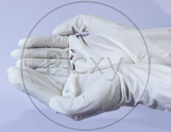 Female Doctor Wearing Medical Latex Gloves In Both Hands Together