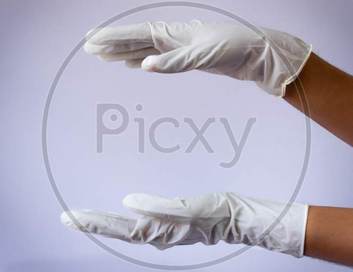 Female Doctor Wearing Medical Latex Gloves In Both Hands