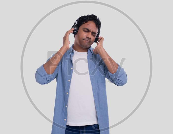 Indian Man Listening To Music. Man Listening Music. Enjoys The Melody. Man Isolated