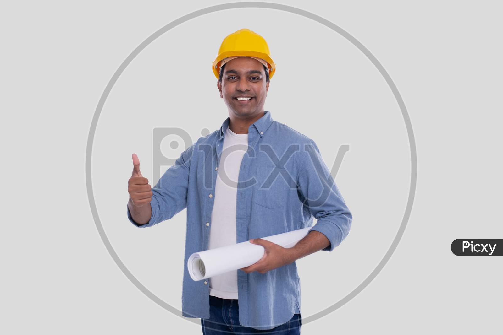 Construction Worker Holding House Plan In Hands Showing Thumb Up. Architect Holding Blueprints. Yellow Hard Helmet.