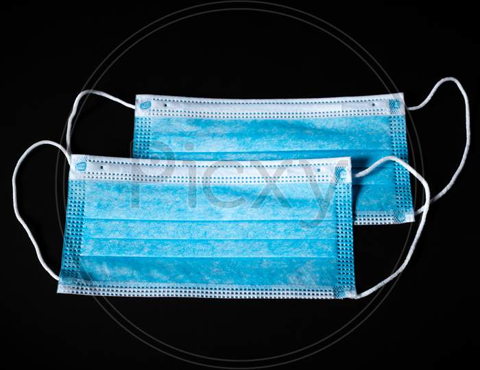 Two Surgical Face Masks In Black Background