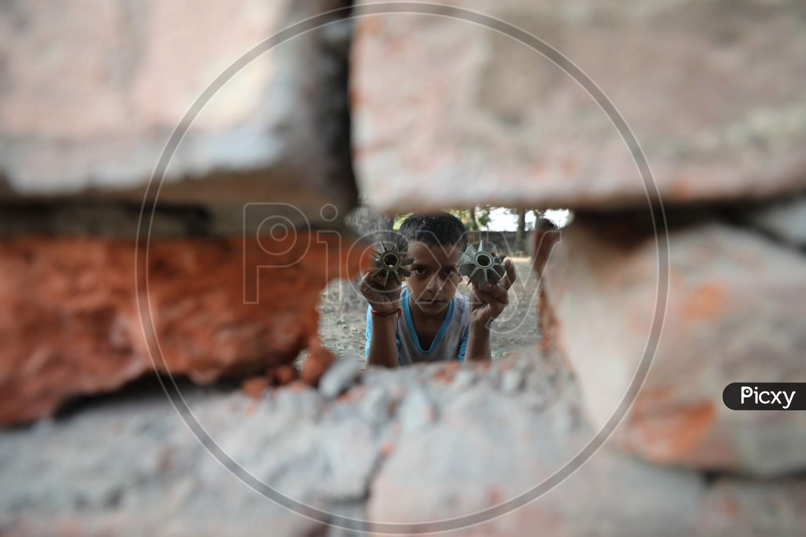 Border villager woman holds the tail unit of a mortar shell allegedly fired from the Pakistani side of the  border in Manyari village of Kathua about 65 kms from Jammu,11 November,2020.