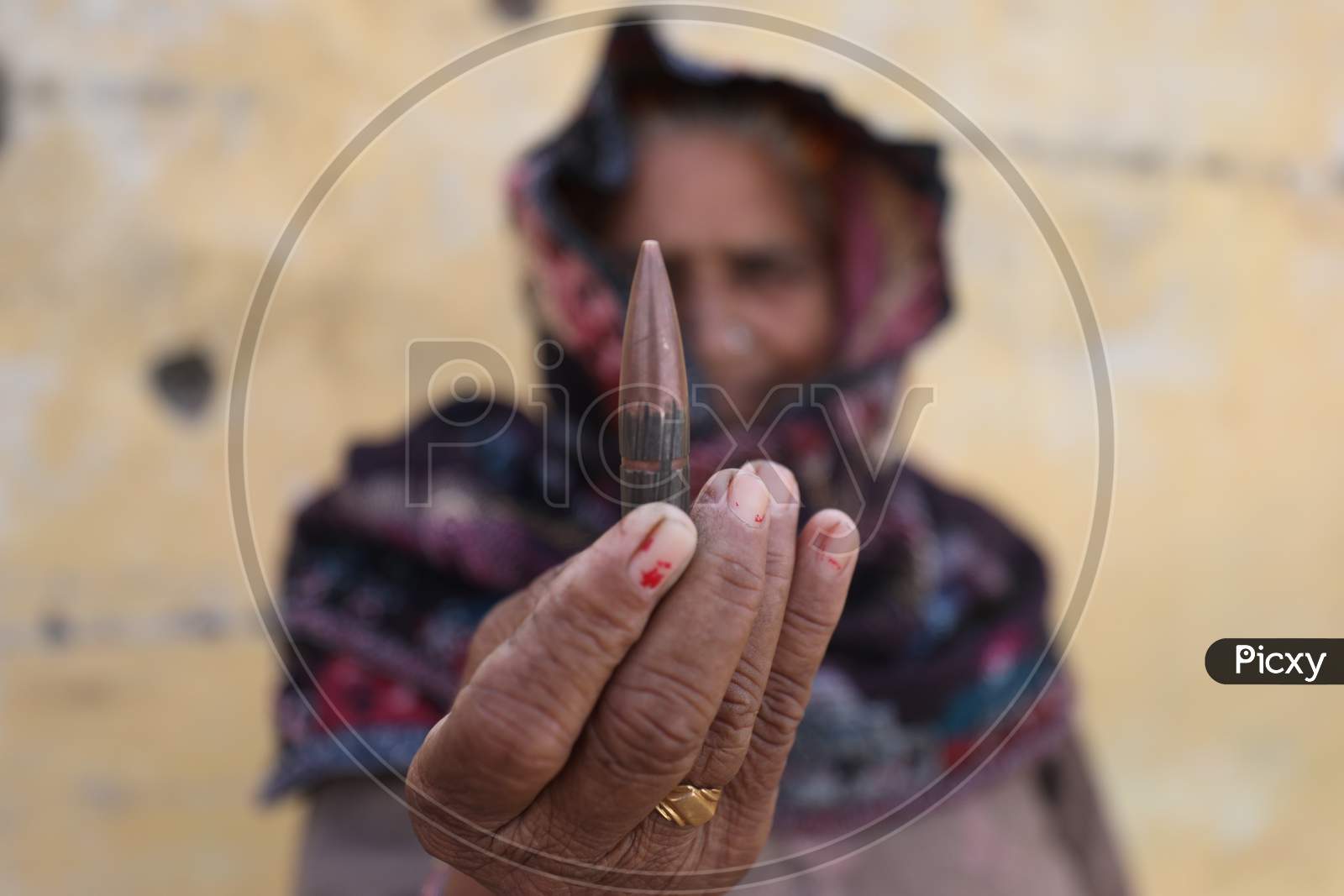 Border villager woman holds bullet allegedly fired from the Pakistani side of the  border in Manyari village of Kathua about 65 kms from Jammu,11 November.2020,