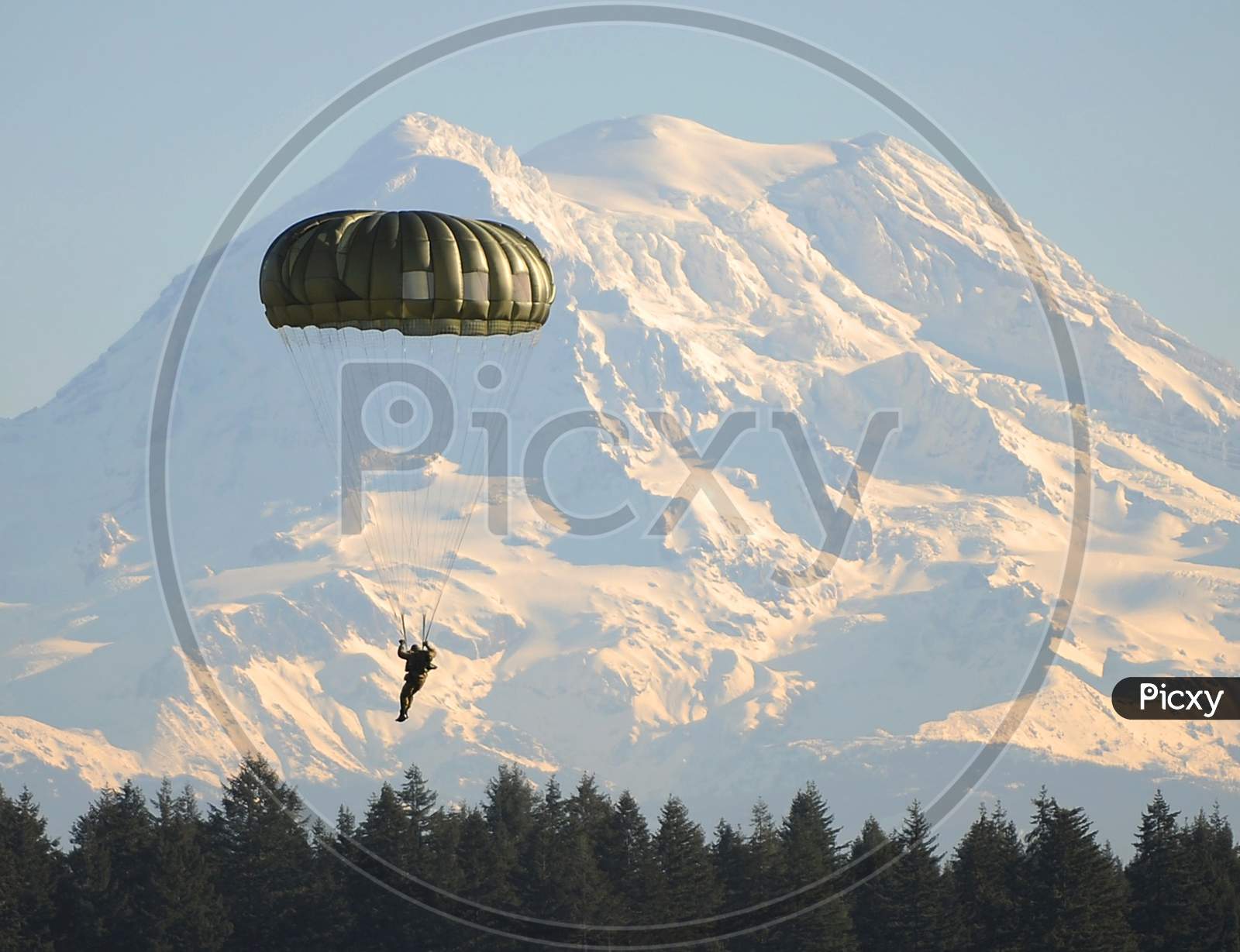 Parachuting In front Of Ice Capped Mountain