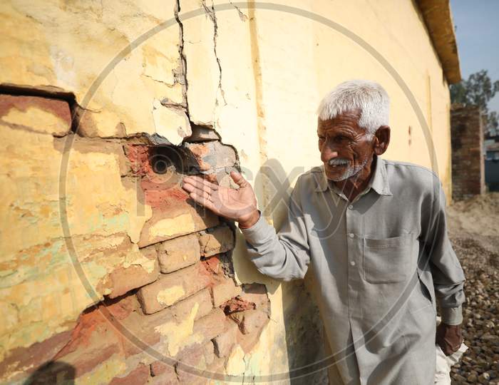 Border villager shows the pockmarked wall of a building damaged by alleged shelling from the Pakistani side of the  border in Manyari village of Kathua about 65 kms from Jammu,11 November,2020.