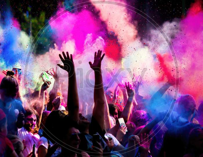 Krakow, Poland - August 25, 2019: Unidentified People Playing With Colors During Hindu Festival Holi. Hands Are Visible Throwing Colors In The Air