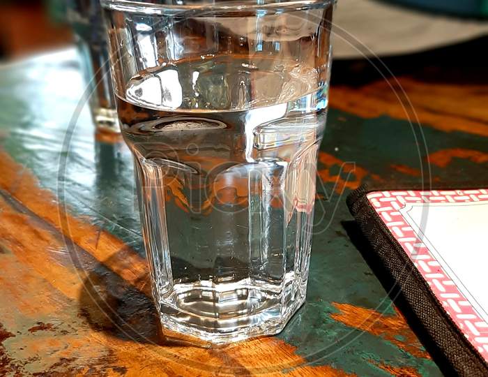 A glass of water on wooden table