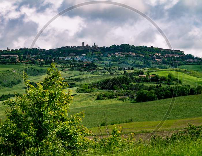 Mountainous Landscape Of Italian Tuscany. Cloudy Day In The Field. Typical View Of The Italian North.