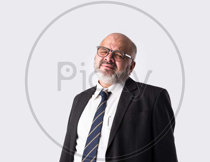 Indian Old Or Senior Businessman Having Headache, Frustration With Confused Expressions