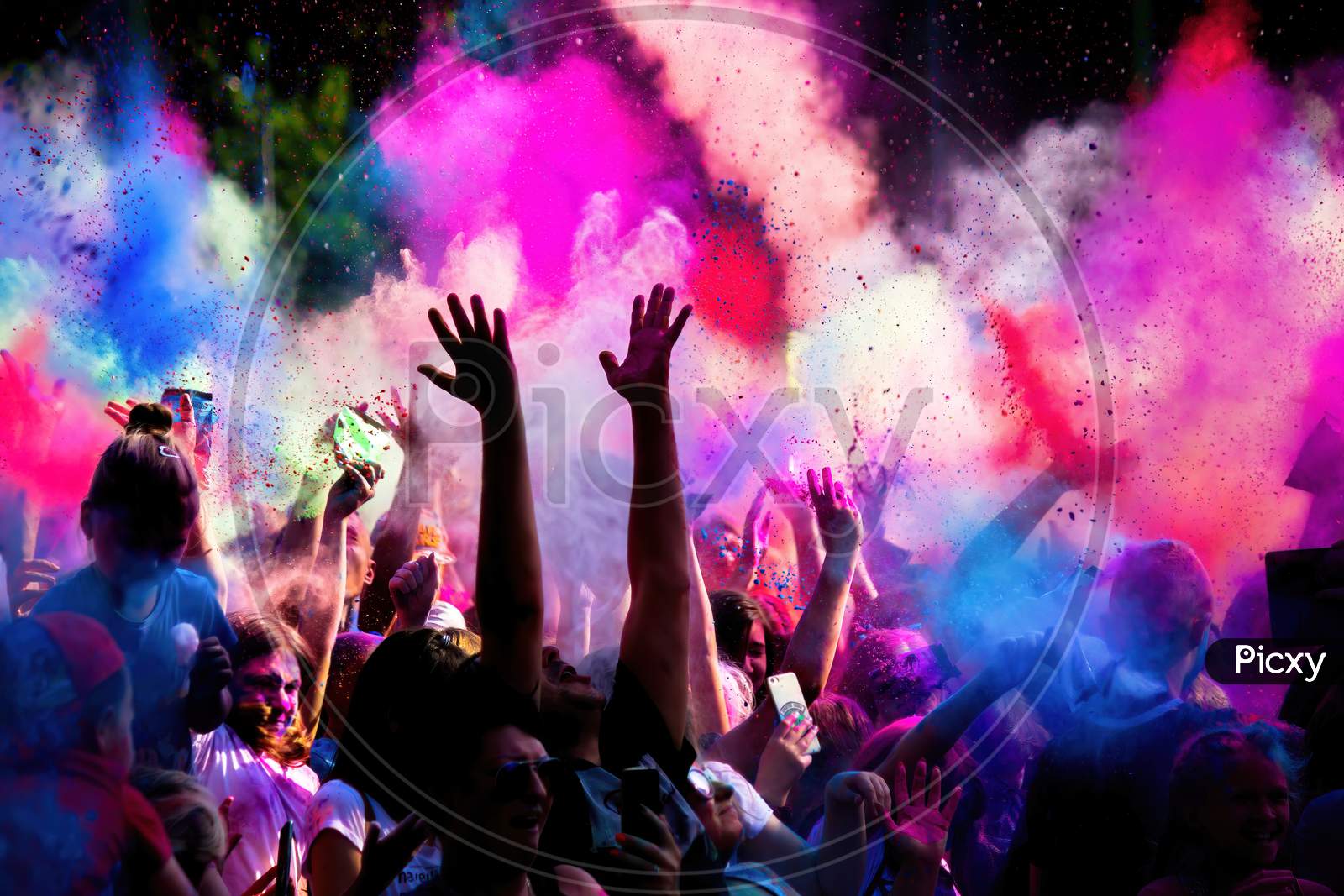 Krakow, Poland - August 25, 2019: Unidentified People Playing With Colors During Hindu Festival Holi. Hands Are Visible Throwing Colors In The Air