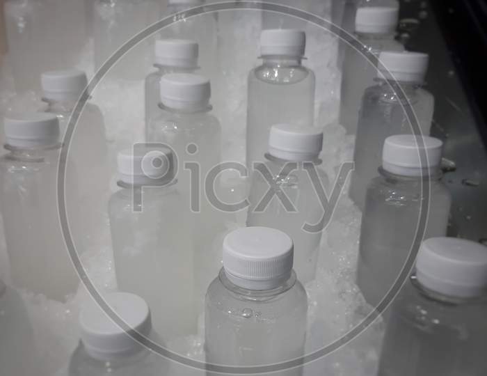 tender coconut juice in bottles placed with ice