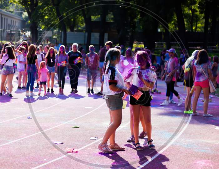 Krakow, Poland - August 25, 2019: Female Students Are Enjoying / Playing With Colors During Hindu Festival Holi.