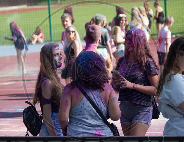 Krakow, Poland - August 25, 2019: Female Students In Group Are Playing With Colors During Hindu Festival Holi