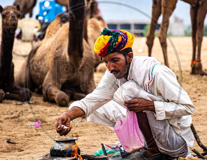 Rajasthani Man Making Food At Pushkar Camel Festival.