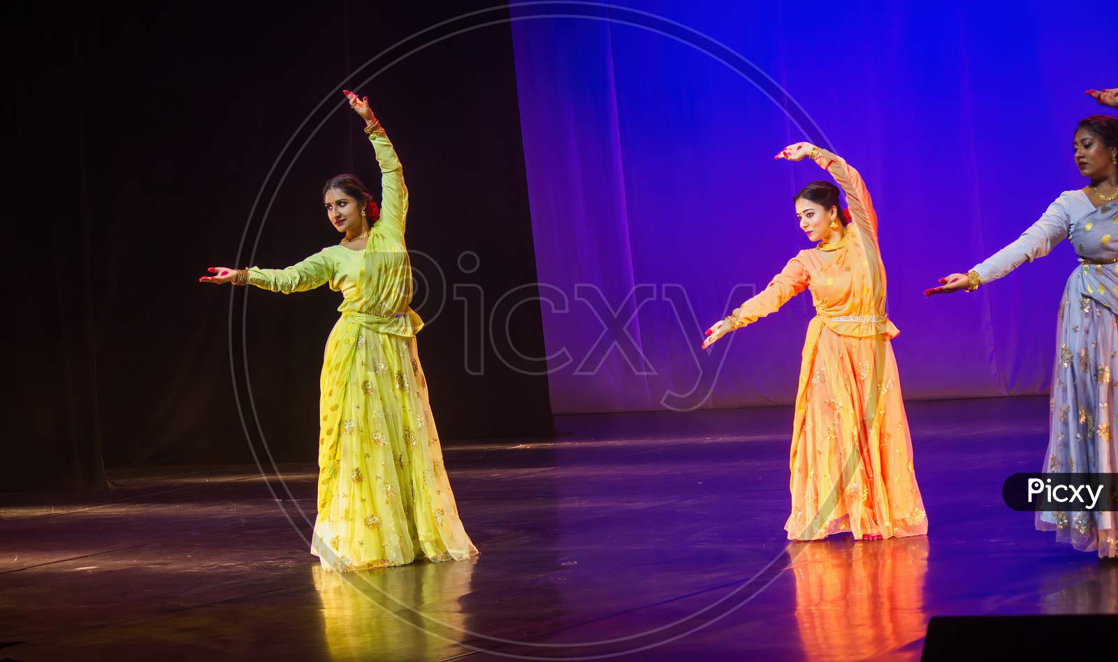Krakow, Poland - April 01, 2019: Girls Dressed Up In Indian Traditional Dress And Performing Indian Classical Dance On Stage During Holi Event