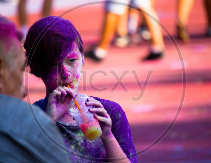 Krakow, Poland - August 25, 2019: Female Student With Powder Color On Faceduring Hindu Festival Holi