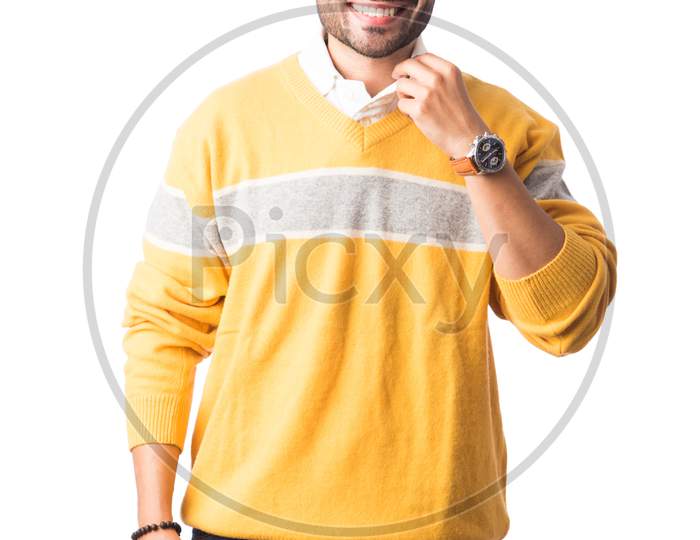 Indian Young Man In Trendy Woollen Sweater Or Winter Wear Standing Isolated Against White