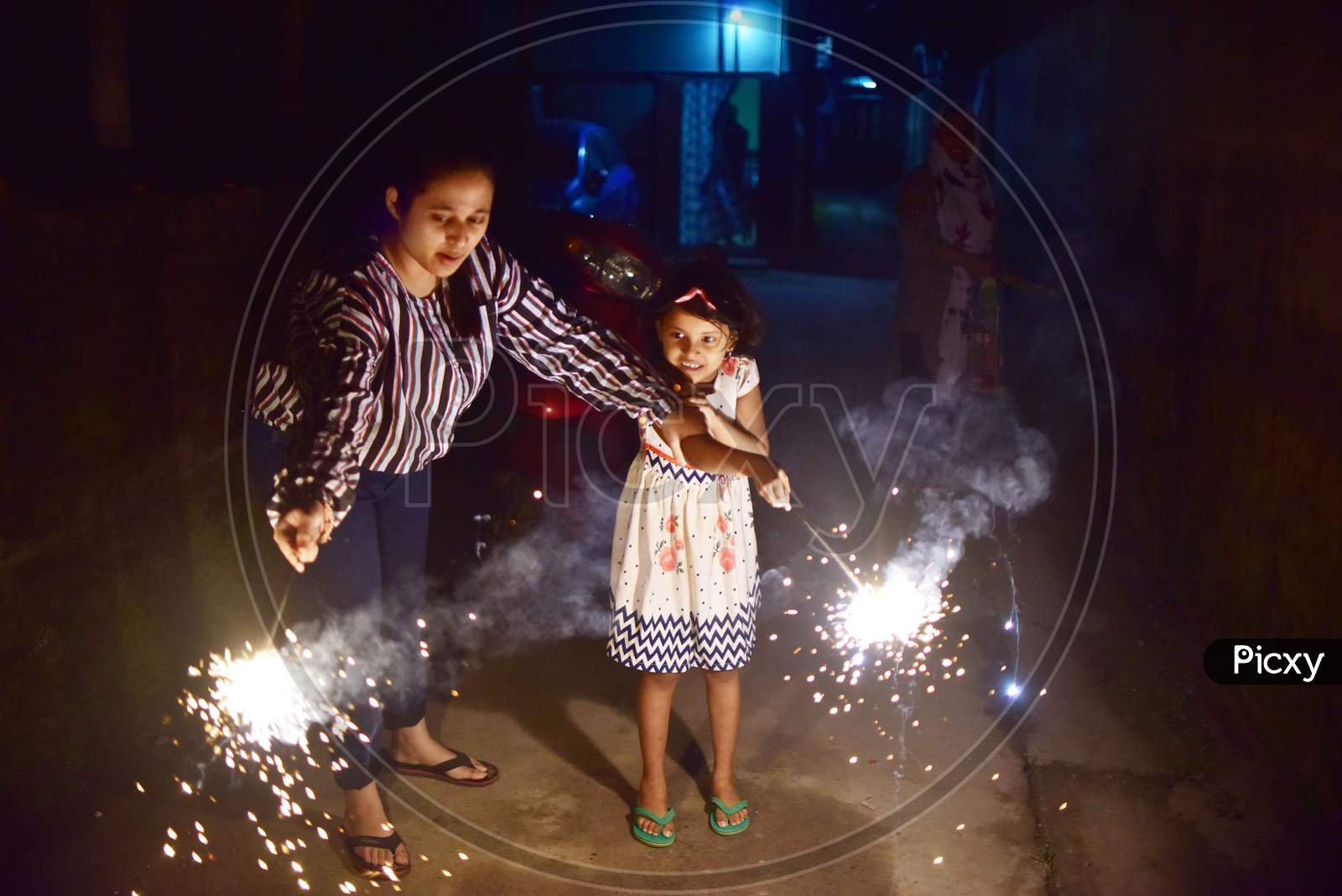 Girls hold sparklers during Diwali celebrations in Nagaon District of Assam on Nov 14,2020.