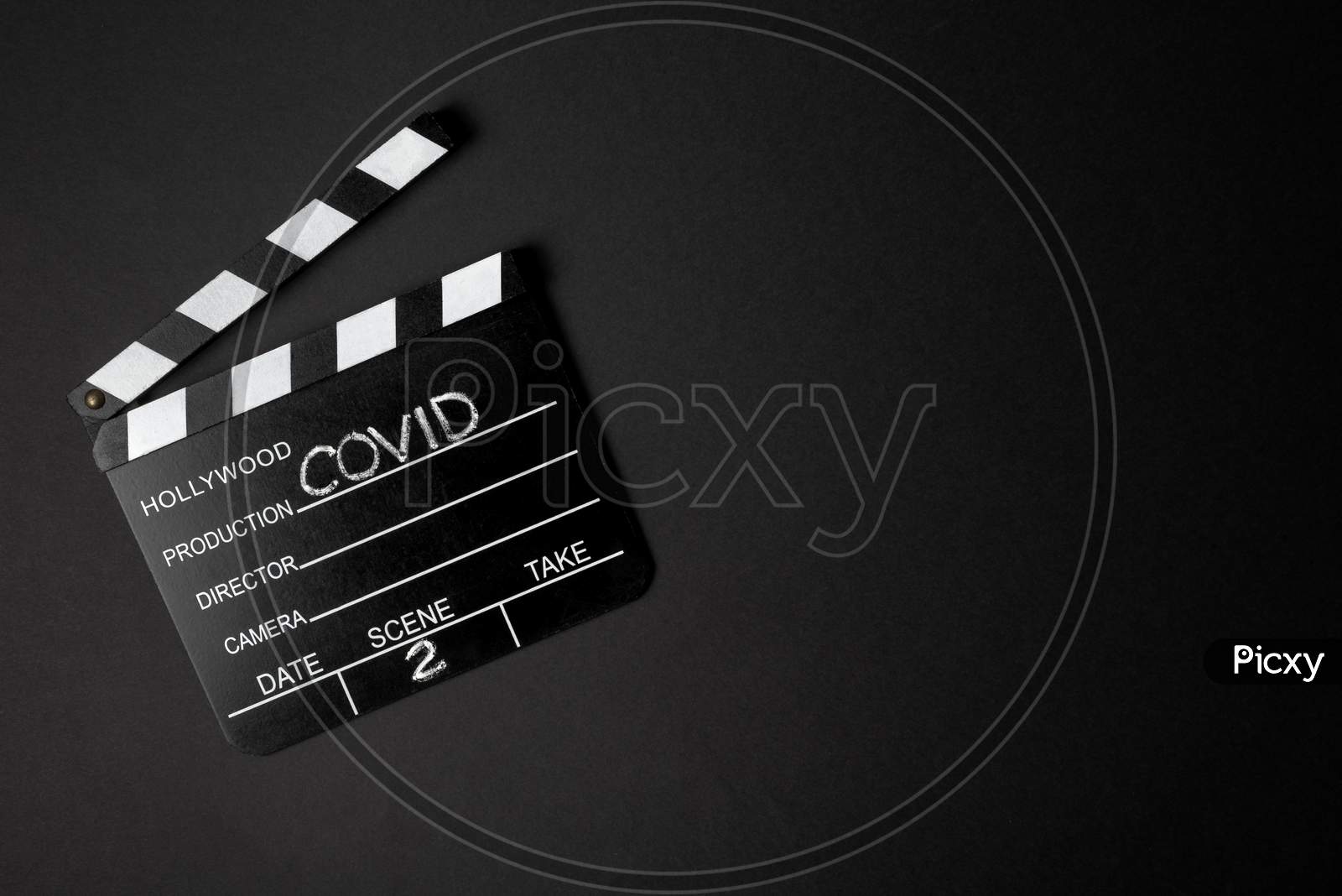 Movie Clapperboard During The Second Wave Of The Coronavirus Pandemic On A Black Background. Covid Concept.
