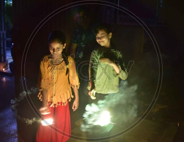 Girls hold sparklers during Diwali celebrations in Nagaon District of Assam on Nov 14,2020.