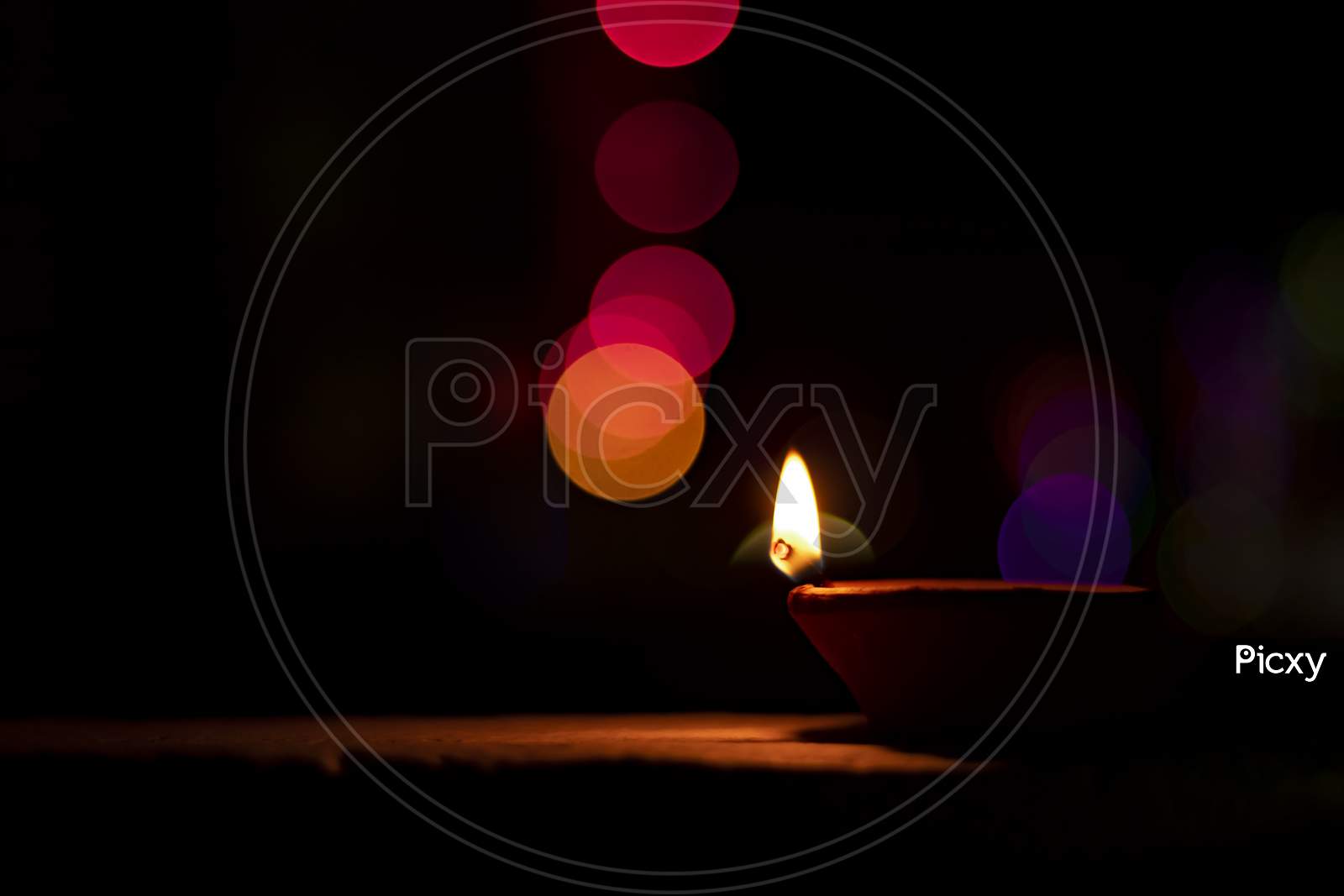 Happy Diwali - Lit Diya Lamp On Street At Night With Bokeh Background