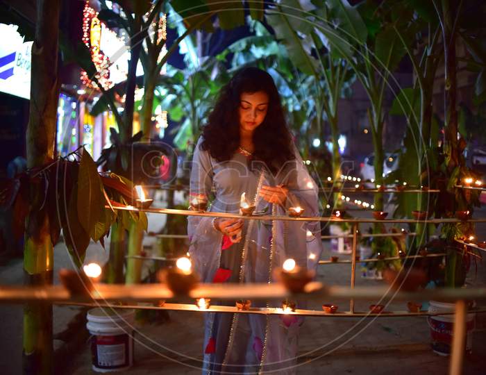 A girl  light lamps on the occasion of Diwali festival in Nagaon District of Assam on Nov 14,2020.