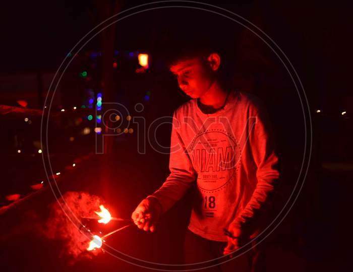A boy  hold sparklers during Diwali celebrations in Nagaon District of Assam on Nov 14,2020.