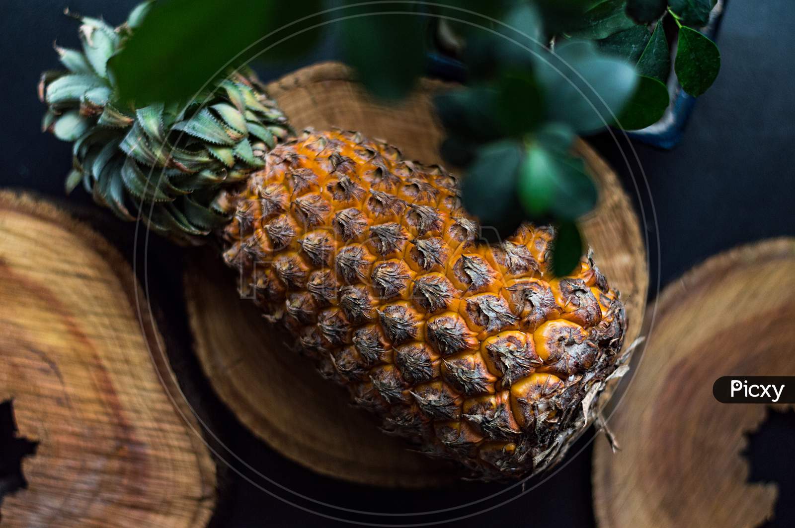 Pineapple on wooden base