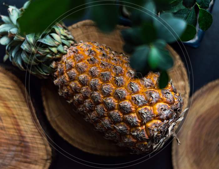 Pineapple on wooden base