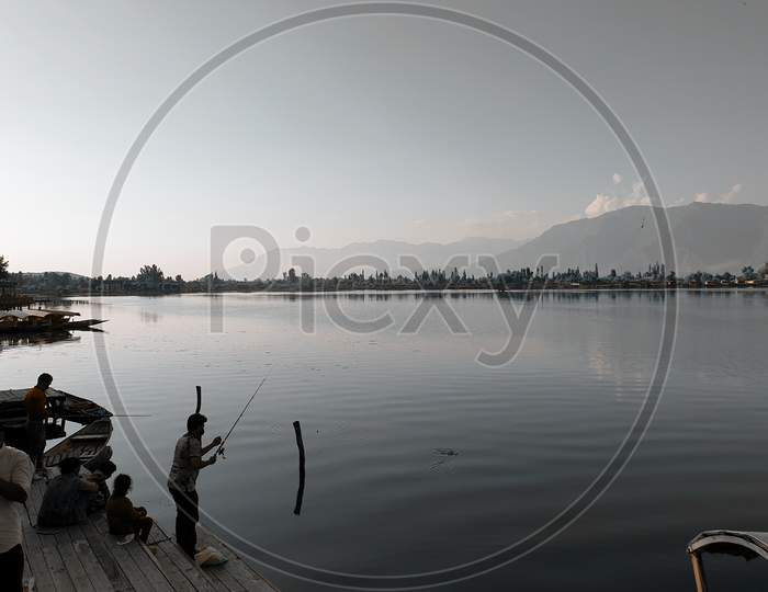 Dal Lake In Srinagar Kashmir With Shikara In Water.