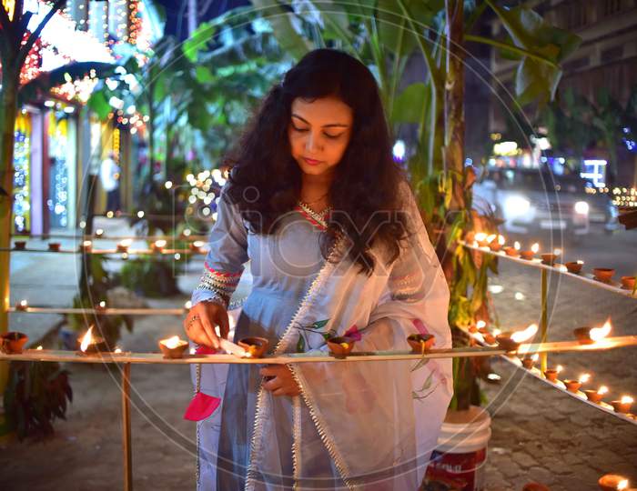 A girl  light lamps on the occasion of Diwali festival in Nagaon District of Assam on Nov 14,2020.