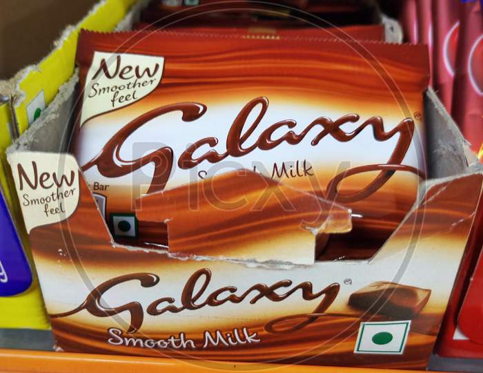 galaxy chocolate kept in a rack or  a box