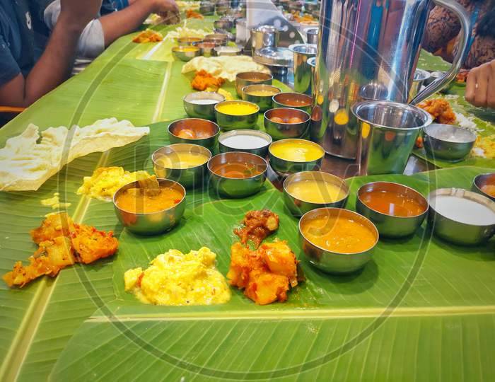 Kerala Onam Feast / Eating Ona-Sadya in banana leaf during the festival of Onam