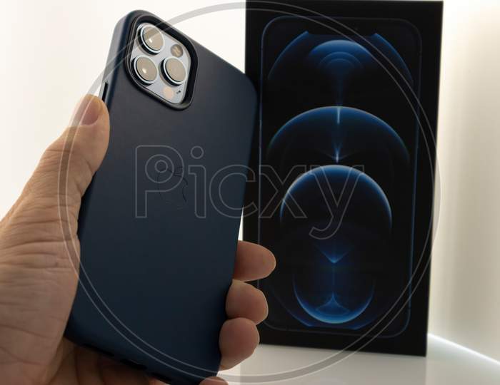 Frankfurt, Germany - November 13th 2020: A german photographer bought the new iPhone 12 Pro Max with MagSafe accessories as the iPhone case and the magnetic wallet, taking pictures of it with case.