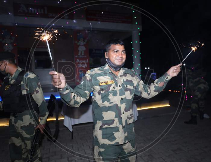 Border security force (BSF) soldiers enjoying crackers as they celebrating Diwali festival at International border outskirts in Jammu  ,14 November,2020.