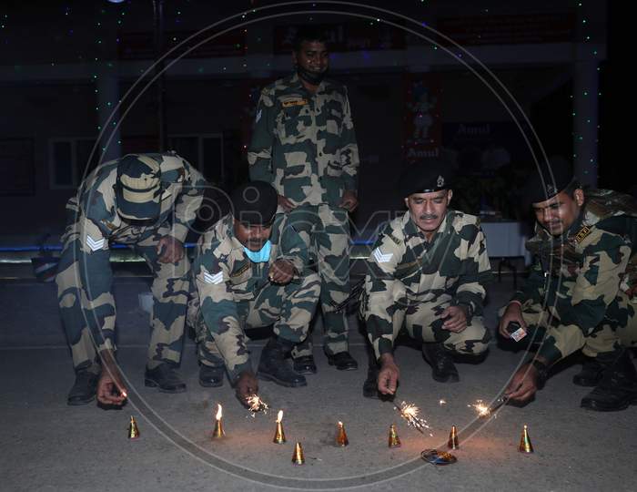 Border security force (BSF) soldiers placing candles near the fence as they celebrating Diwali festival at International border outskirts in Jammu  ,14 November,2020.