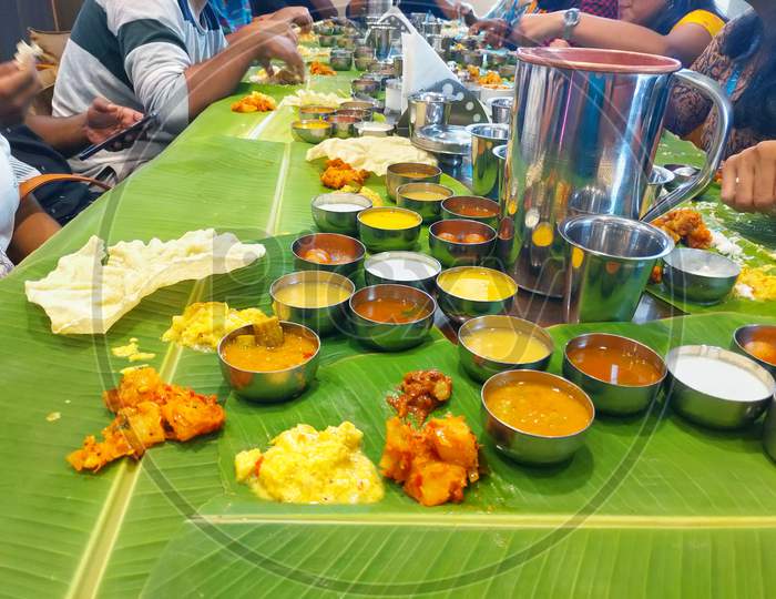 Kerala Onam Feast / Eating Ona-Sadya in banana leaf during the festival of Onam