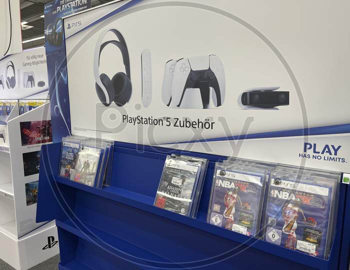 Frankfurt, Germany - 14th November 2020: A german photographer looking for the new Playstation 5 (PS 5) in a Saturn market, taking pictures of the first available games for the console.
