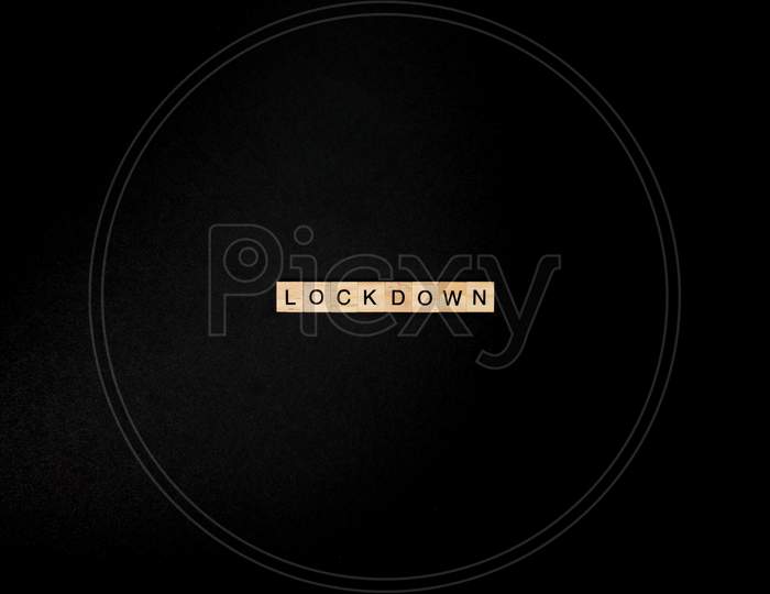 Wooden Letters On A Black Background Forming The Word “Lockdown”. Second Wave During Coronavirus Pandemic Concept.
