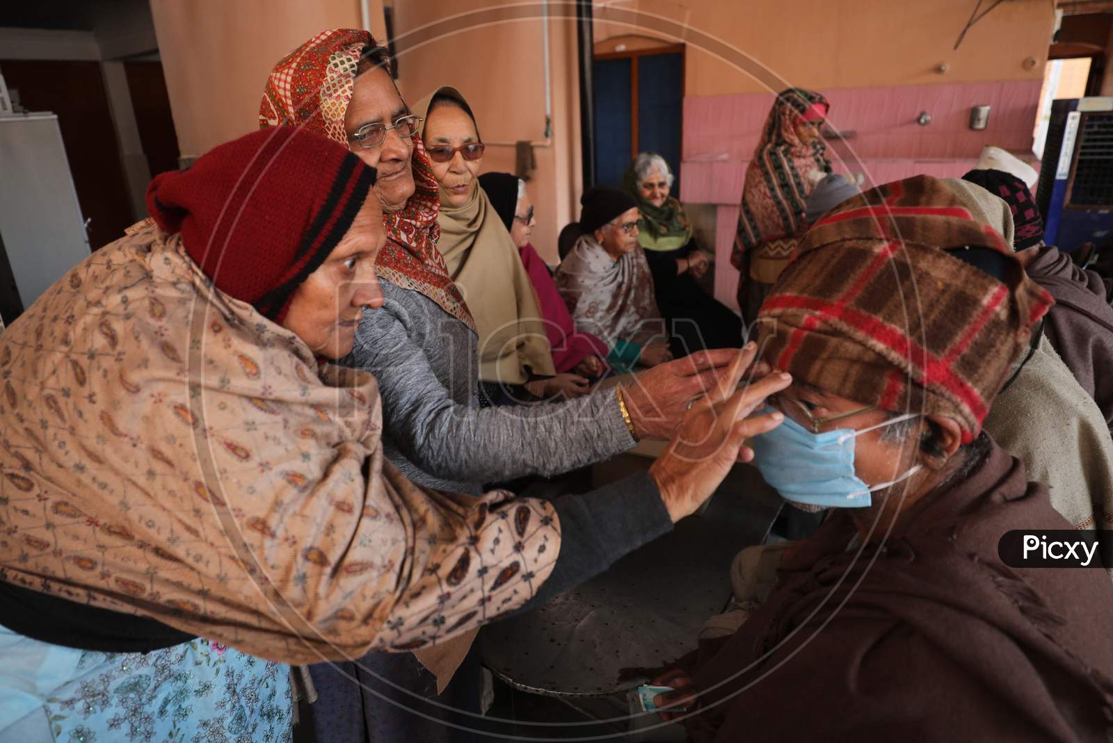 Old age Home Woman marks a tilaka on an old man's forehead, during the Bhai Dooj festival, in Jammu,16 November.2020.
