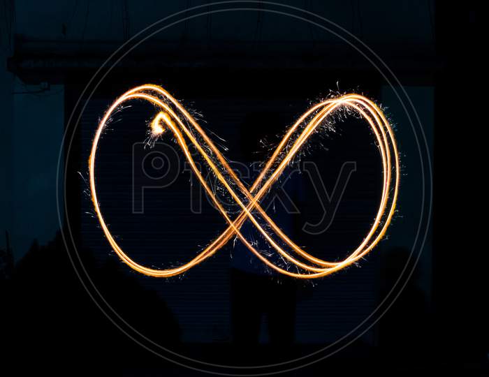 Infinity symbol made by sparkler long exposure