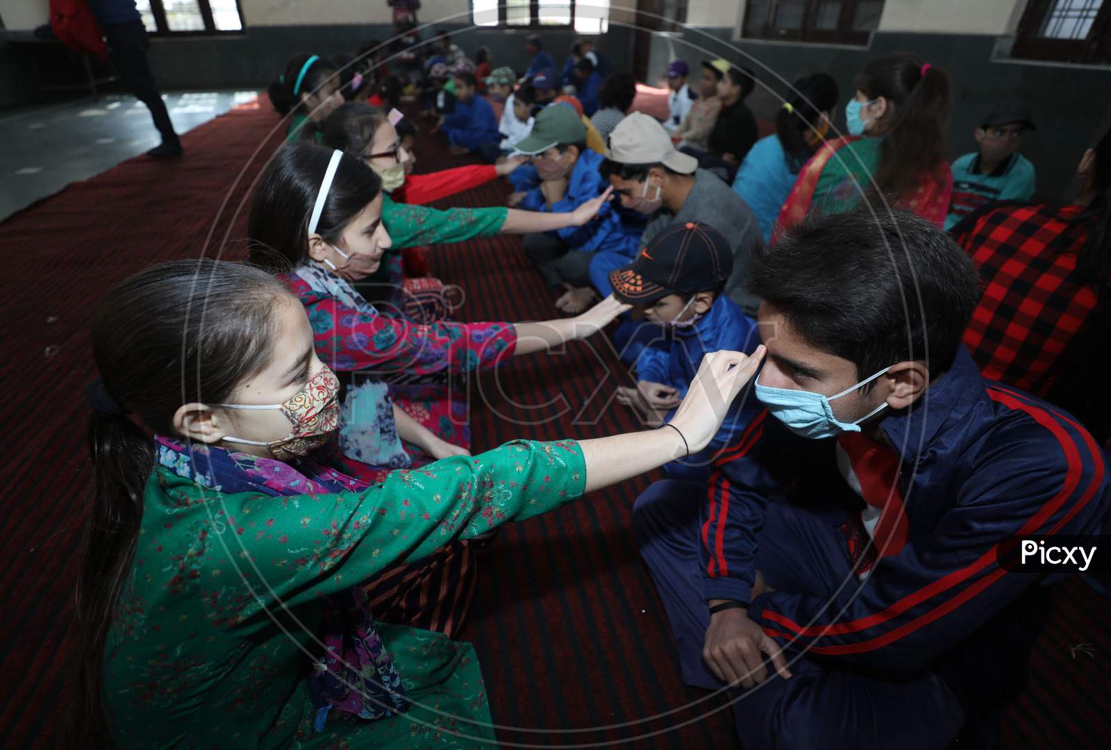 Orphan girls mark a tilaka on a boy's forehead, during the Bhai Dooj festival, at an orphanage in Jammu ,16 November.2020.