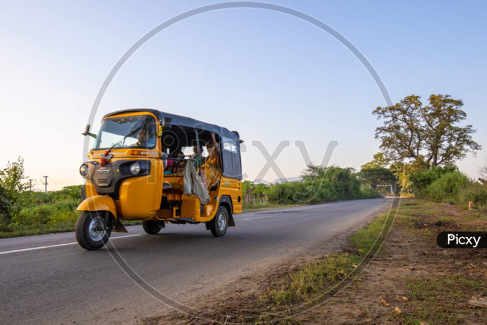 Auto rickshaw travelling with passengers on Indian State Highway