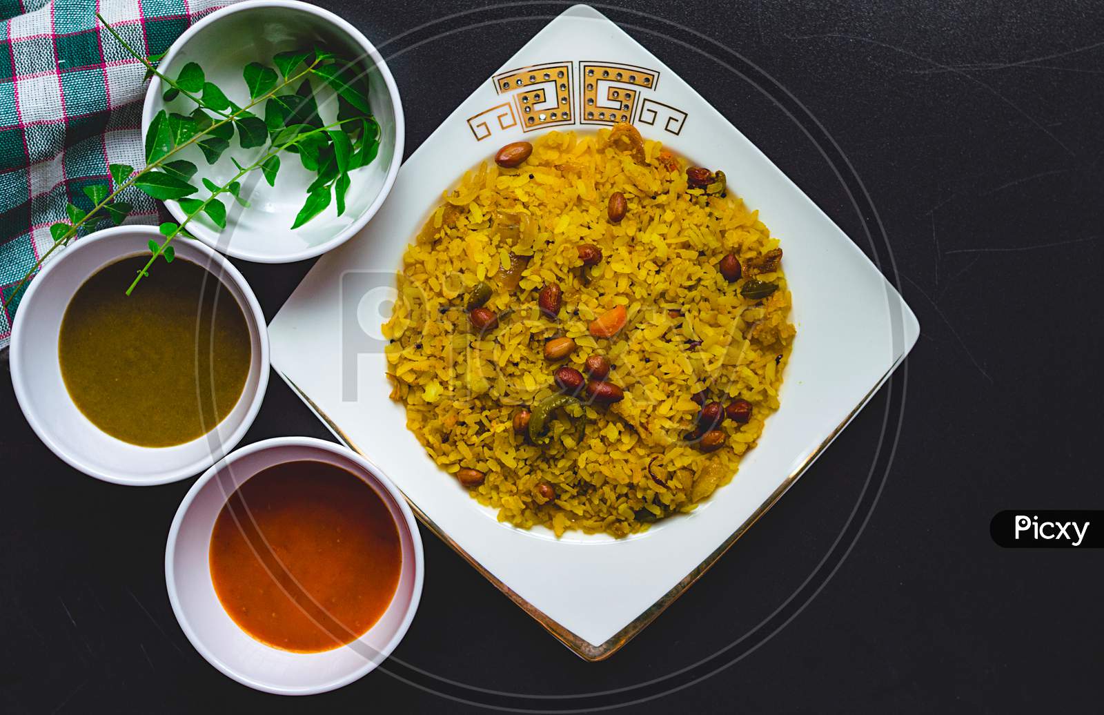 Poha on a plate with different chutneys