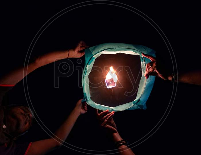 person , paper/sky lantern on diwali 2020 held by Man and woman