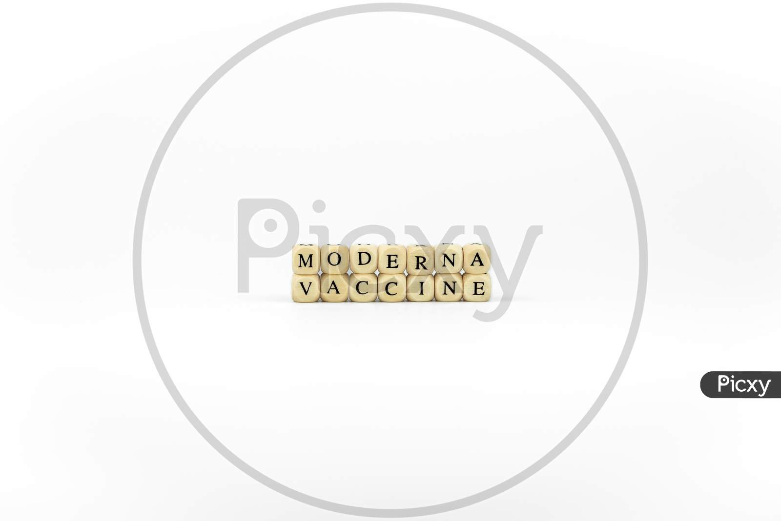 The Name Of Pharmaceutical Company Moderna Written With Wooden Letters On A White Background. Race To Find The Vaccine Against The Coronavirus Pandemic. Covid Concept.